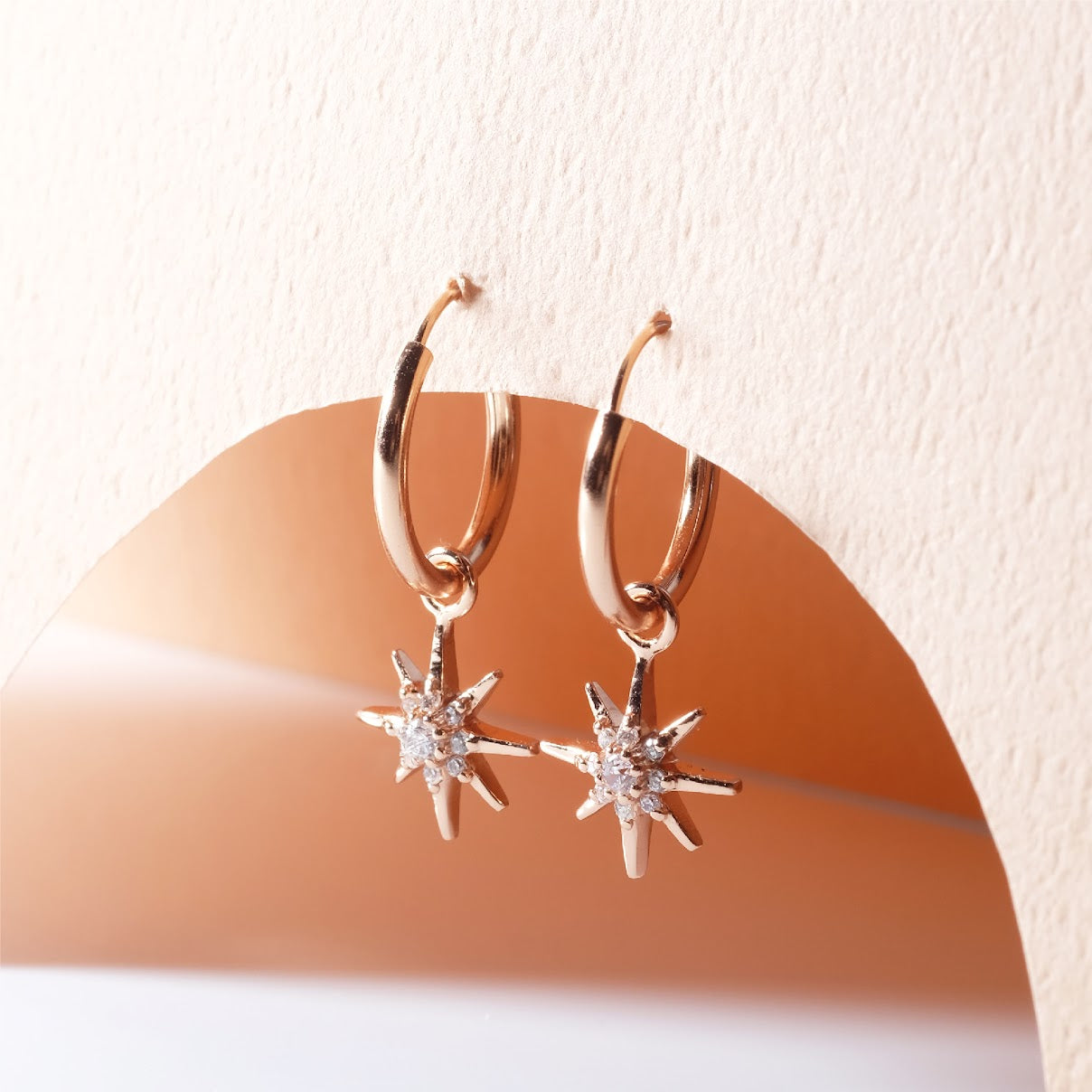 Small hoop earrings with dangling star ER011